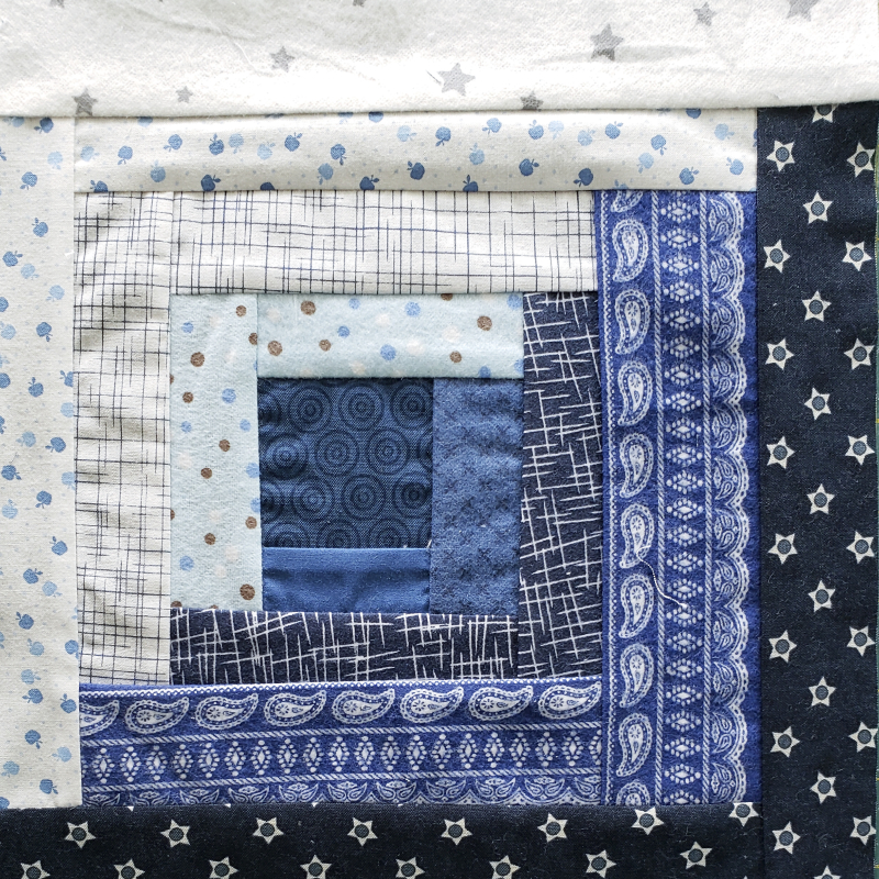 Scrappy log cabin quilt sqare